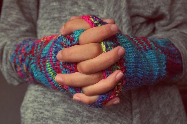 ClaspedHandsWearingKnittedGloves
